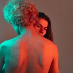 Intimate couples posing artistically in softly-lit private photography studio