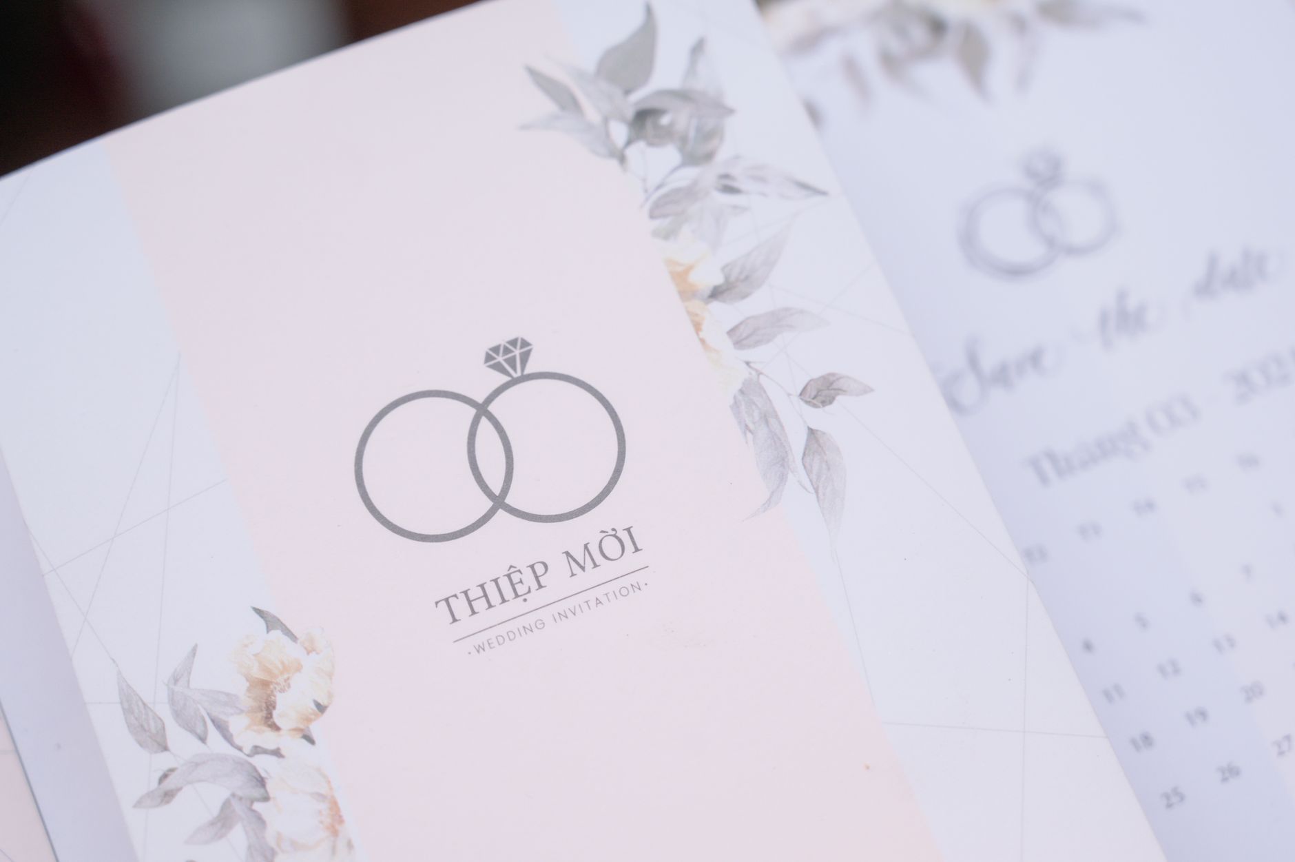 Elegant wedding invitation card with floral design and calligraphy text