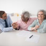 Senior couple reviewing hospital indemnity insurance plan documents at home