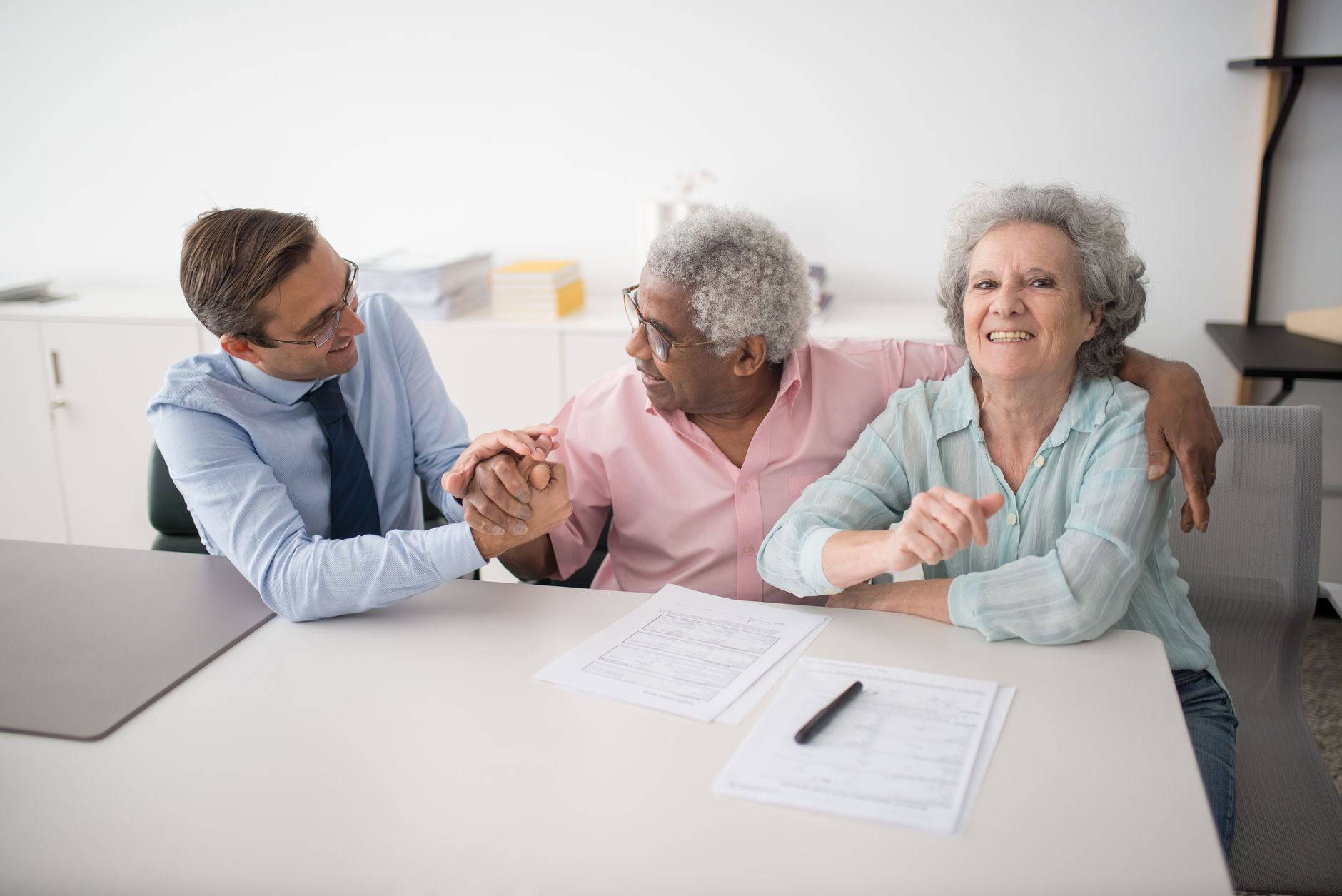 Senior couple reviewing hospital indemnity insurance plan documents at home
