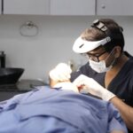 Professional dermatologist examining patient skin with advanced medical imaging technology