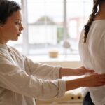 Chiropractor adjusting patient spine for arthritis pain management