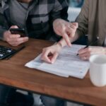 Disabled person reviewing financial documents and SSI benefit information at home