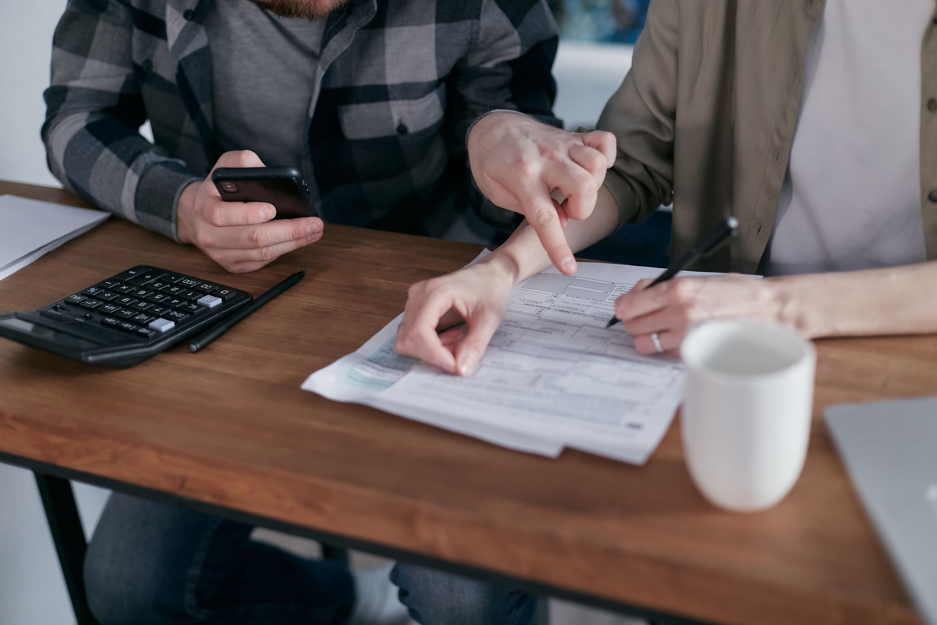 Disabled person reviewing financial documents and SSI benefit information at home