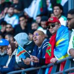 Diverse boxing fans watching live stream together on digital devices