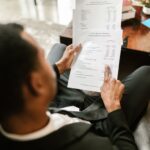 Professional woman in business attire reviewing financial documents and city budget reports