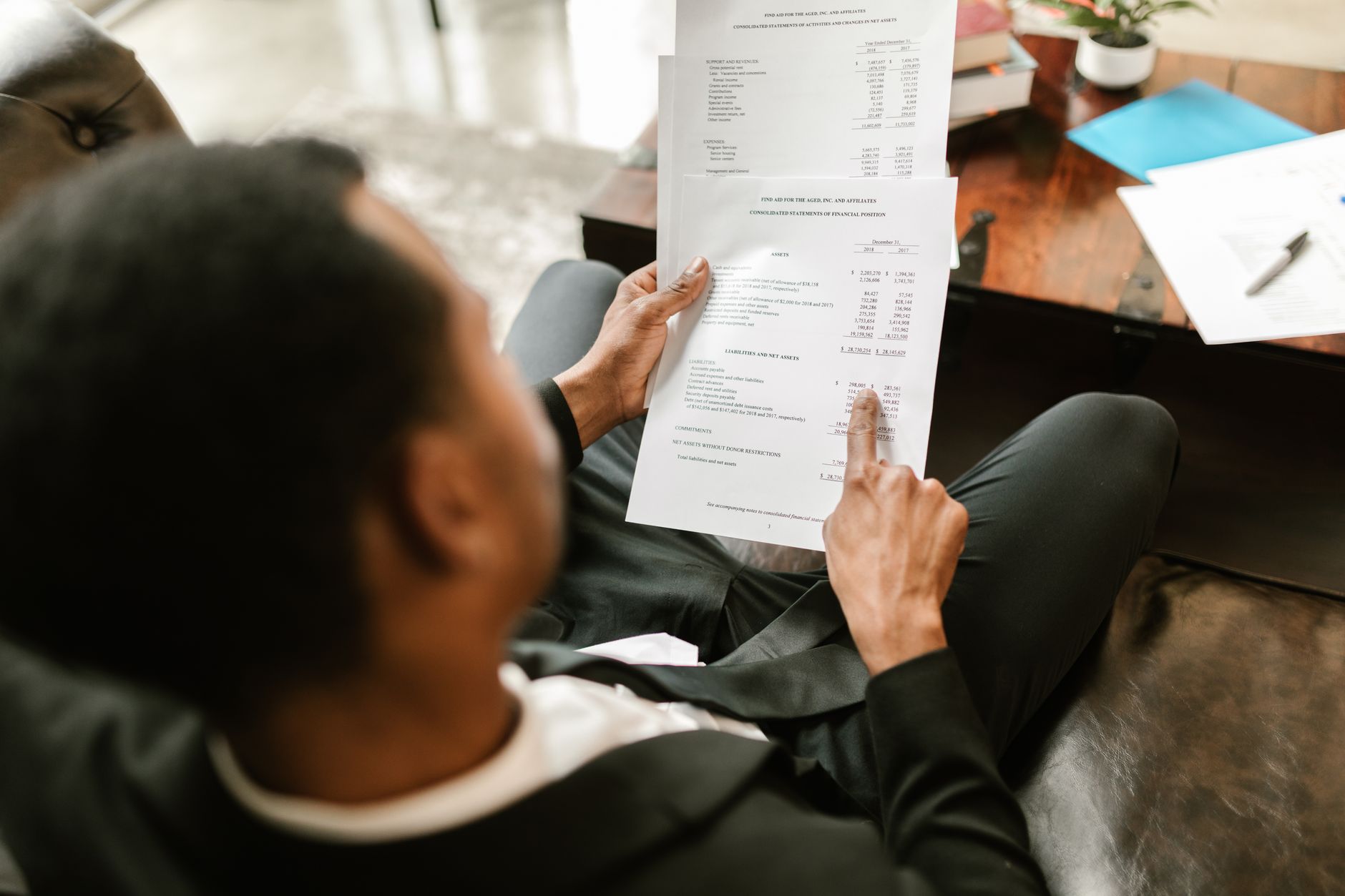 Professional woman in business attire reviewing financial documents and city budget reports