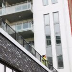 Construction foreman in hard hat reviewing salary documents and negotiation notes