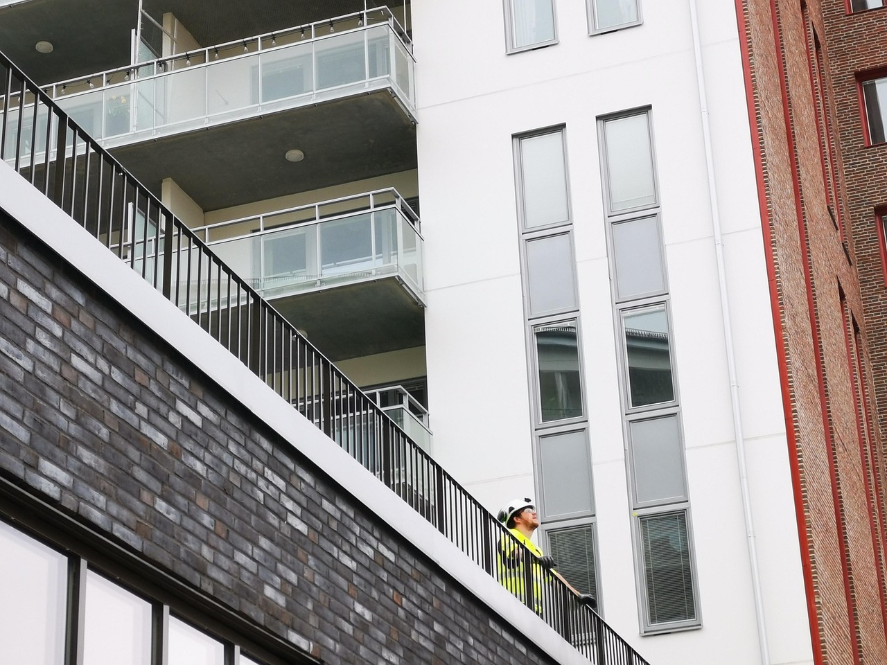 Construction foreman in hard hat reviewing salary documents and negotiation notes