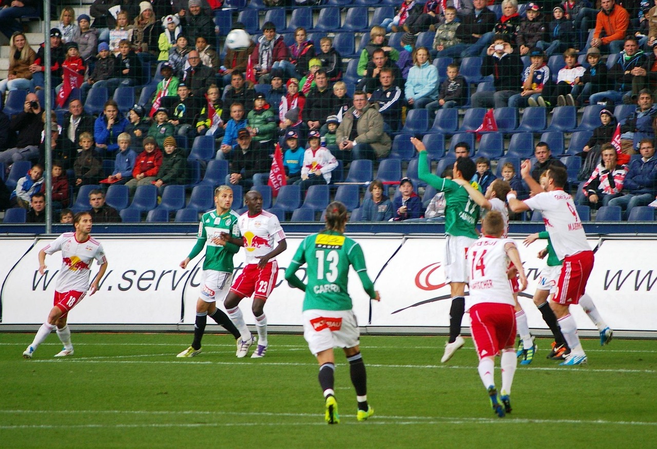 Football stadium crowd with players on field during live match action