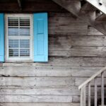 Professional window installer measuring and fitting new window in Coral Gables home