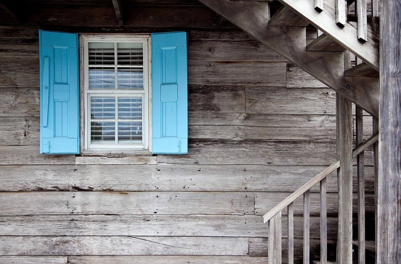 Professional window installer measuring and fitting new window in Coral Gables home