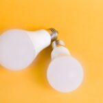 Bright LED light bulbs illuminating a modern outdoor patio at dusk