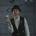 Magician performing card trick with deck of playing cards