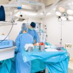 Surgeon performing operation with advanced medical equipment in hospital