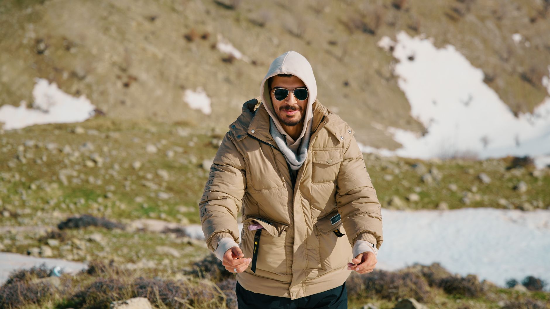 Man wearing stylish winter jacket in snowy outdoor environment