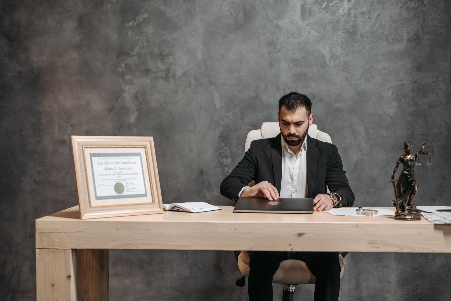 Professional lawyer in suit working at desk with legal documents