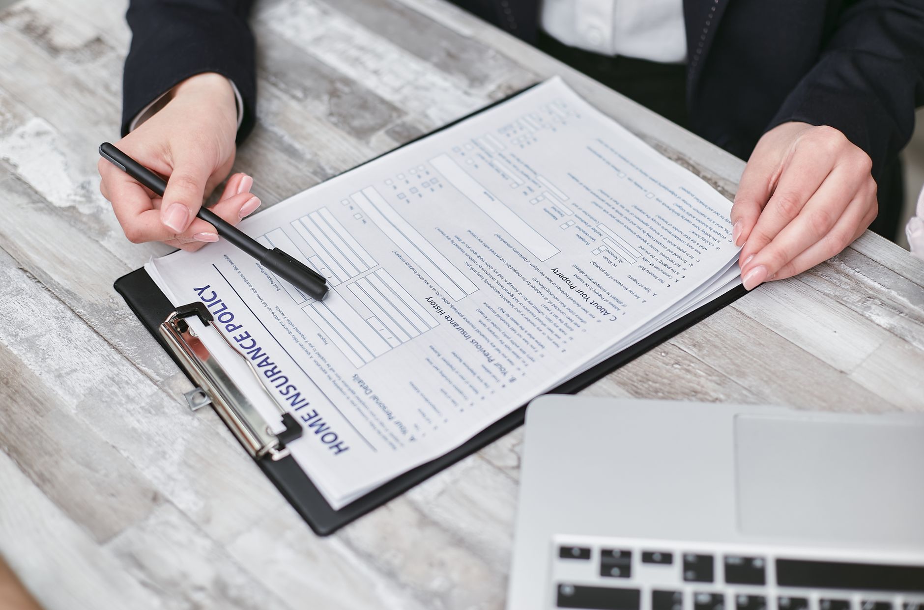 Person reviewing health insurance enrollment documents and options on laptop