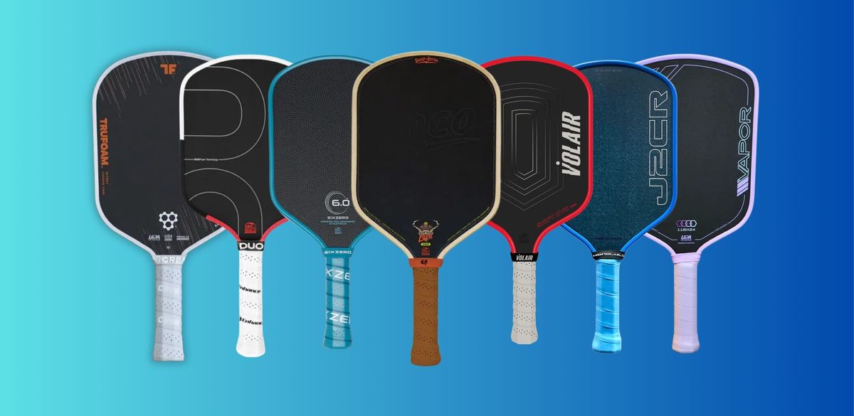 A collection of various pickleball paddles displayed against a vibrant blue background.
